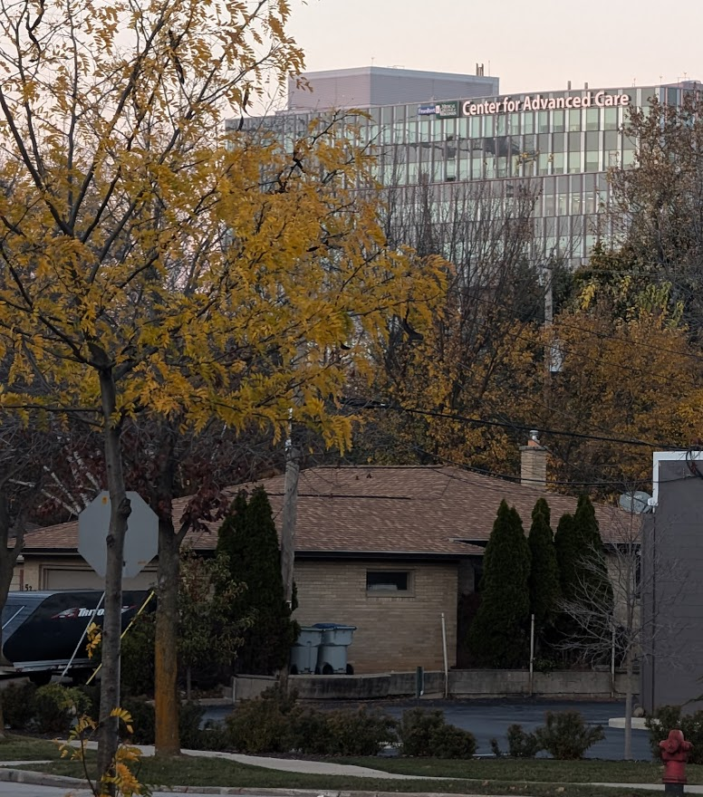 Photograph of the Center for Advanced Care in the background.